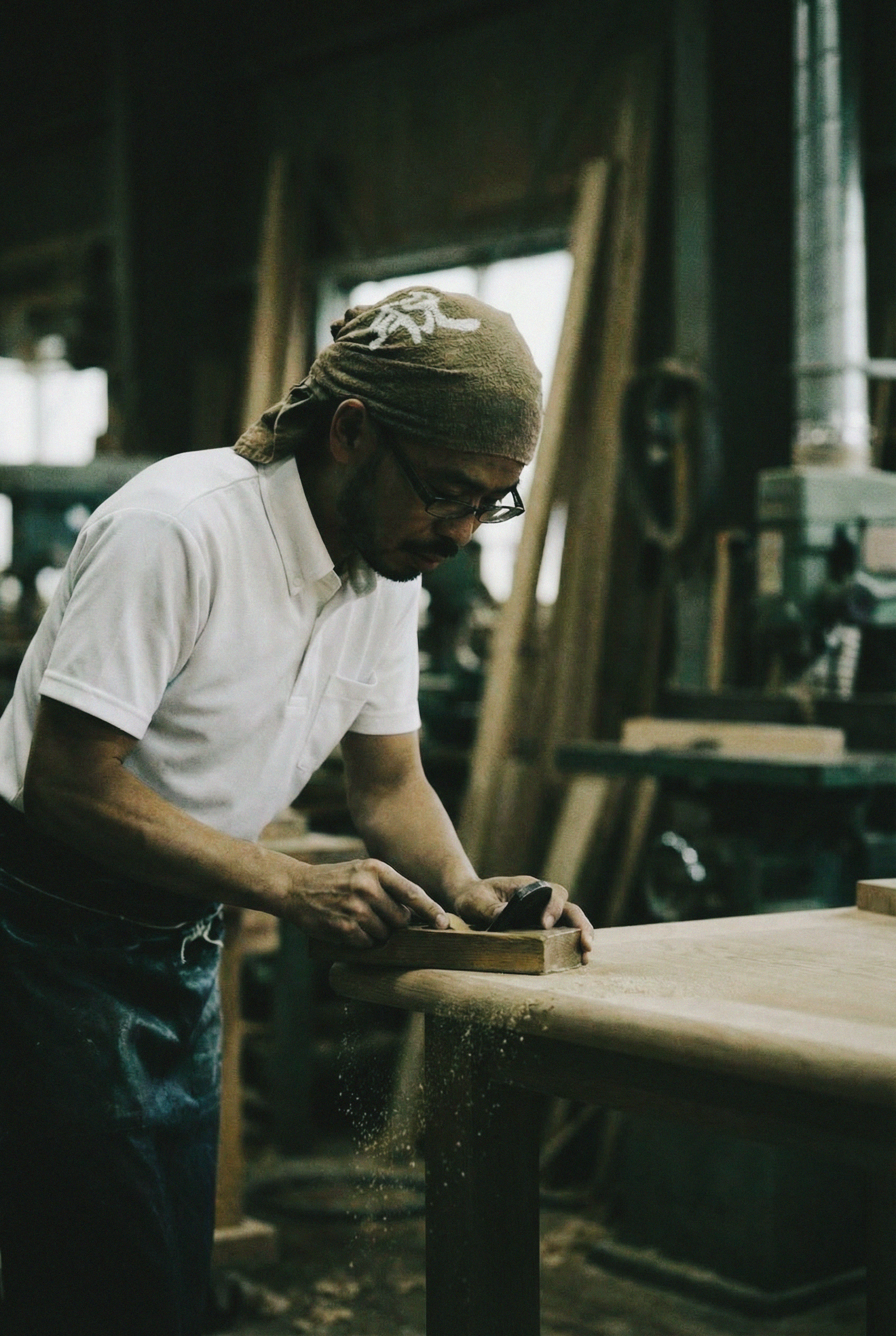 Craftsman hand-sanding oak